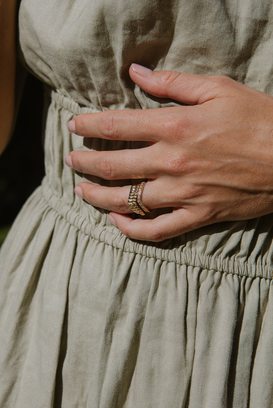 Eternity ring on model, stacked with two other gold rings