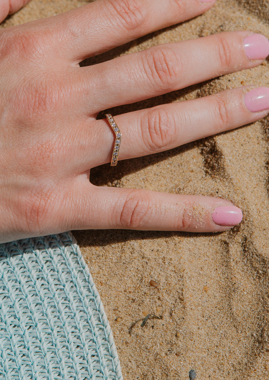 Close up of eternity ring on hand, in the sand