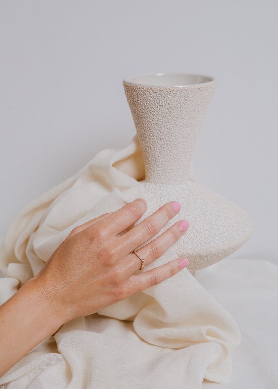 Ring on model, with hand against white vase and white fabric